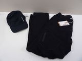black pants and a hat are sitting on a white table