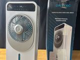an electric fan sitting on top of a wooden table next to a box of ear buds