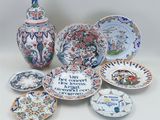 many different types of plates and vases on the table
