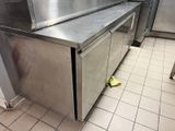 stainless steel counter top in a commercial kitchen with tiled flooring