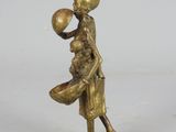 bronze figurine of a boy holding a bowl and a ball