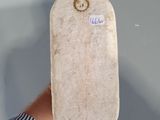 a person holding a skateboard with a sticker on it