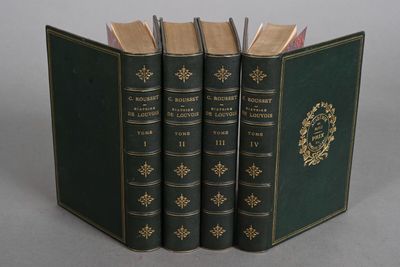 three books are stacked on top of each other on a table