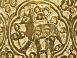 a close up of a gold vase with a design on it