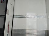 a white truck with a door open in a building