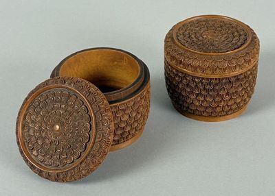 two small wooden boxes sitting next to each other on top of a table