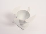 a small white bowl that is on a white surface