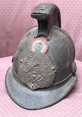 a helmet that is sitting on a pink surface