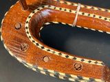 an image of a wooden horseshoe shaped object on a table