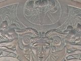 a silver plate with a picture of a woman and angels on it
