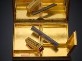 a gold box with a pair of scissors in it