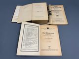 three old books sitting on top of each other on a table