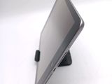 a tablet computer sitting on a stand on a white surface