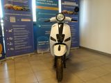 a scooter that is parked in a showroom