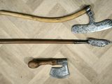 three different types of axes on a wooden floor