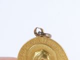 a gold medal with a picture of a woman on it
