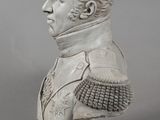bust of a man in a military uniform on a wooden base