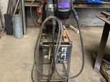 a welding machine that is sitting in a garage