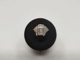 a white gold and diamond ring on a black surface