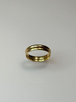 a close up of a gold ring on a white surface