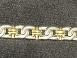 an image of a close up of a metal bracelet on a black surface