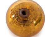 a yellow ball with a hole in it on a white surface
