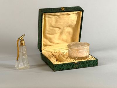 a small glass bottle with a gold lid next to a small glass bottle with a gold lid