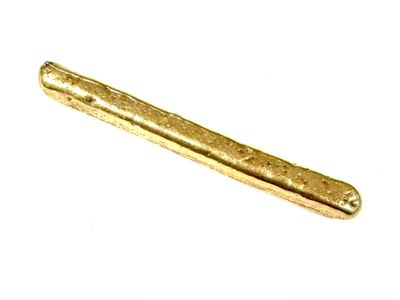 a gold colored metal object on a white surface