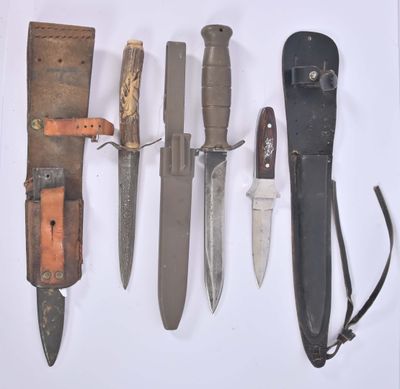 many different types of knives on a white surface