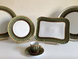 three plates and a cup sitting on a table