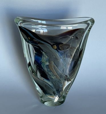 a glass vase with a blue and black design on it