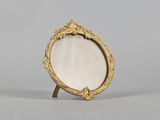 an image of a gold frame with a mirror on it