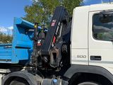 a blue dump truck that is parked in the parking lot
