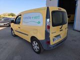 the van is parked in front of a garage with other cars