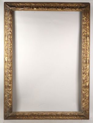 a gold framed mirror on a wall with a white background