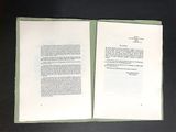 a book open on a table with a black background