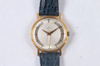 a watch that is sitting on a white surface