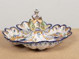 a decorative bowl with a bird on it on a table