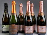 six bottles of champagne are lined up in a row on a table