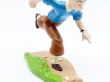 a toy figurine of a boy on a surfboard
