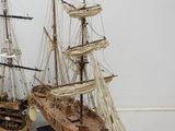 two model ships that are sitting side by side on a table