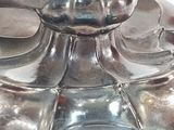 a close up of a silver plate with a candle on it