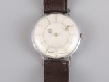 an image of a close up of a wrist watch on a gray surface