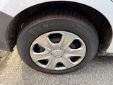 a close up of a tire on a white car