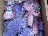a cardboard box filled with purple and pink bath bombs