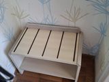 a wooden bench in the corner of a room