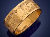 a close up of a gold ring on a blue background