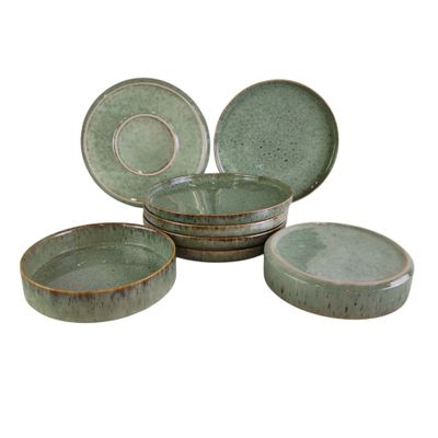 four pieces of green pottery sitting on top of each other