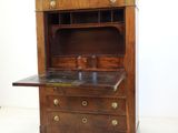 a wooden cabinet with a marble top on a white floor