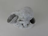 a small figurine of a baby sitting in a bowl